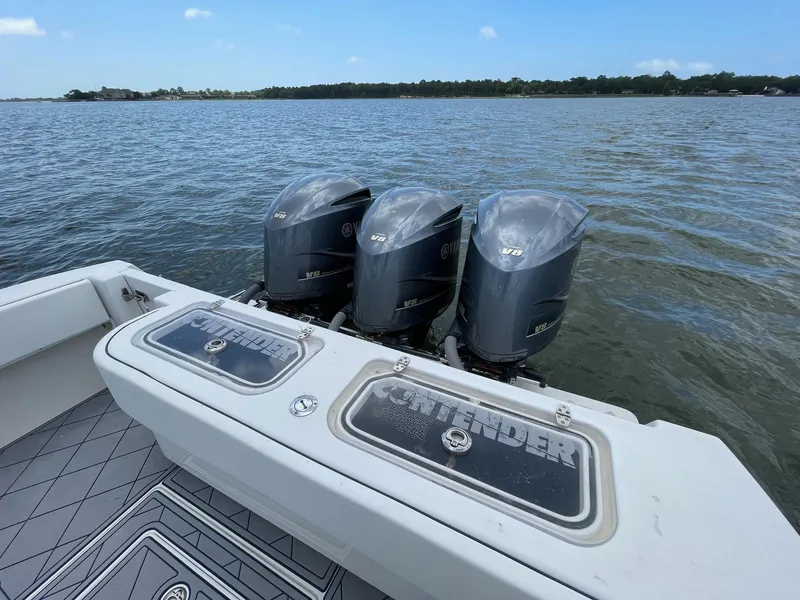 Slide: The Image of 2009 Contender 39 Tournament boat with triple V8 engines on a calm lake. - 14