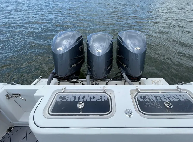 Slide: The Image of 2009 Contender 39 Tournament boat with triple Yamaha V8 engines on water. - 15