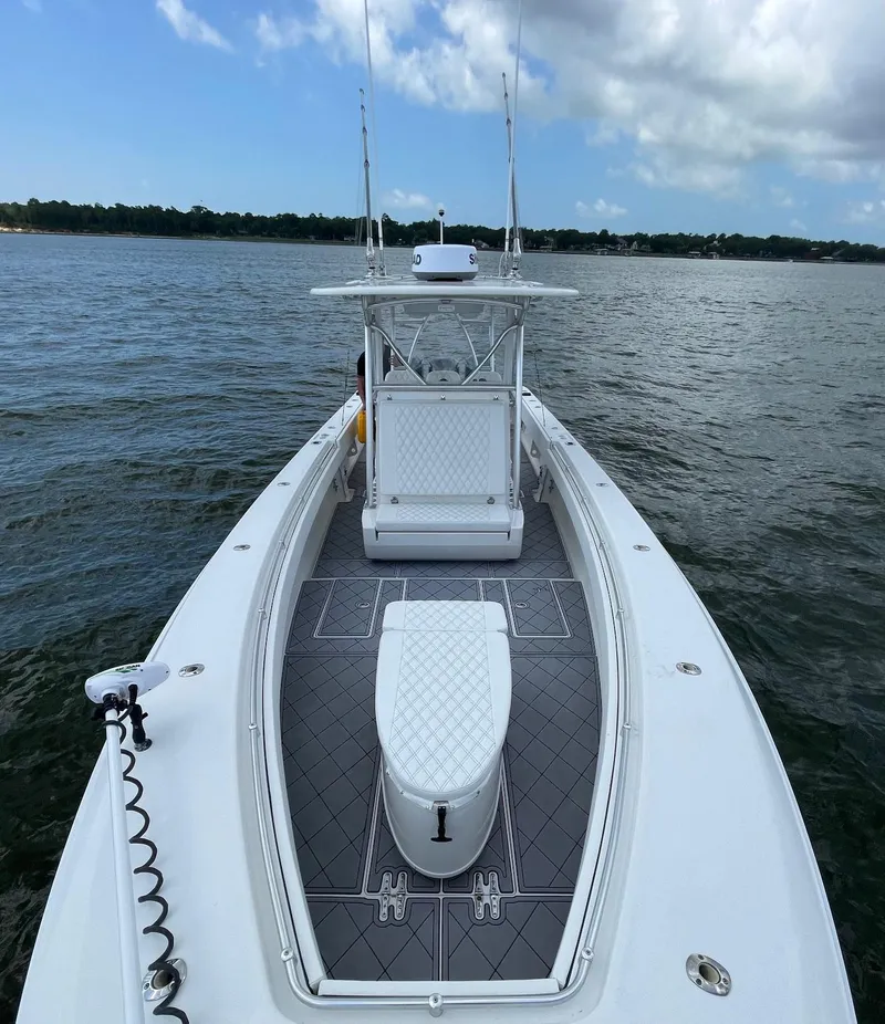 Slide: The Image of 2009 Contender 39 Tournament boat on water, featuring sleek design and spacious deck. - 16