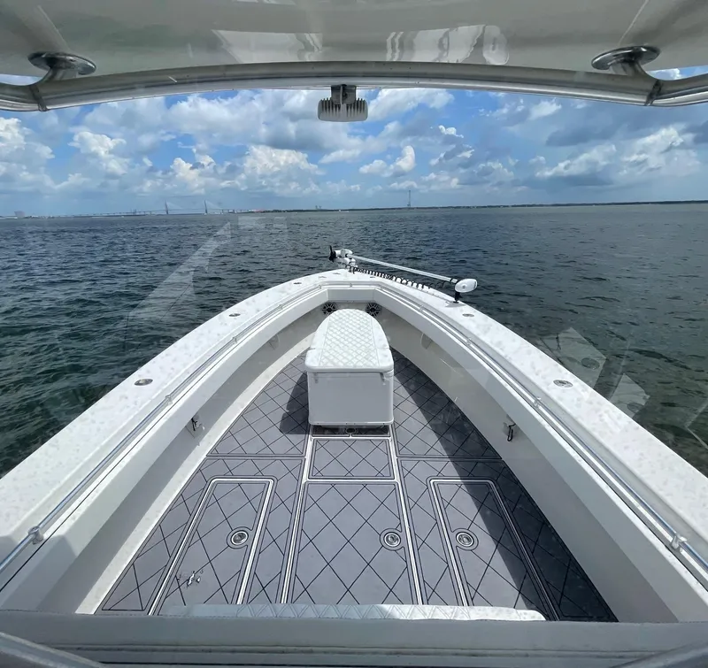 Slide: The Image of 2009 Contender 39 Tournament boat on open water, featuring spacious deck and seating. - 18