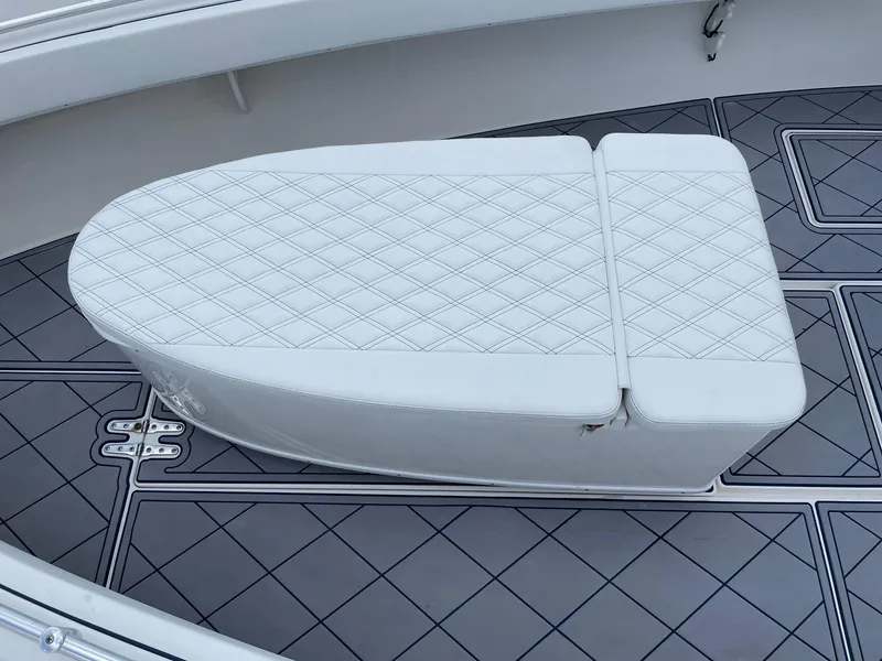 Slide: The Image of 2009 Contender 39 Tournament boat with diamond-stitched white seating on a patterned deck. - 19