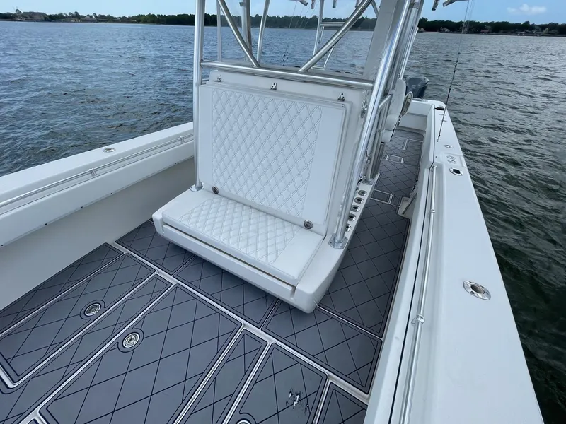 Slide: The Image of 2009 Contender 39 Tournament boat interior with diamond-patterned seating and deck, on calm water. - 20