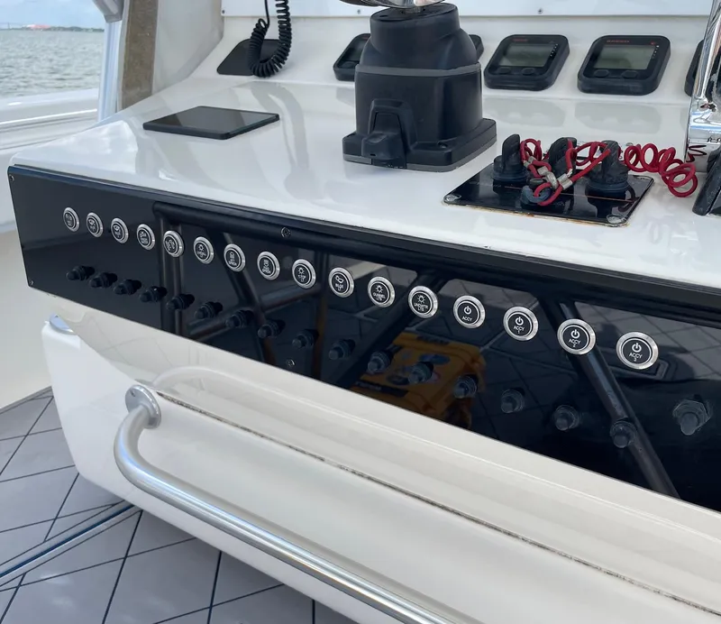 Slide: The Image of Control panel of a 2009 Contender 39 Tournament boat with various switches and displays. - 21