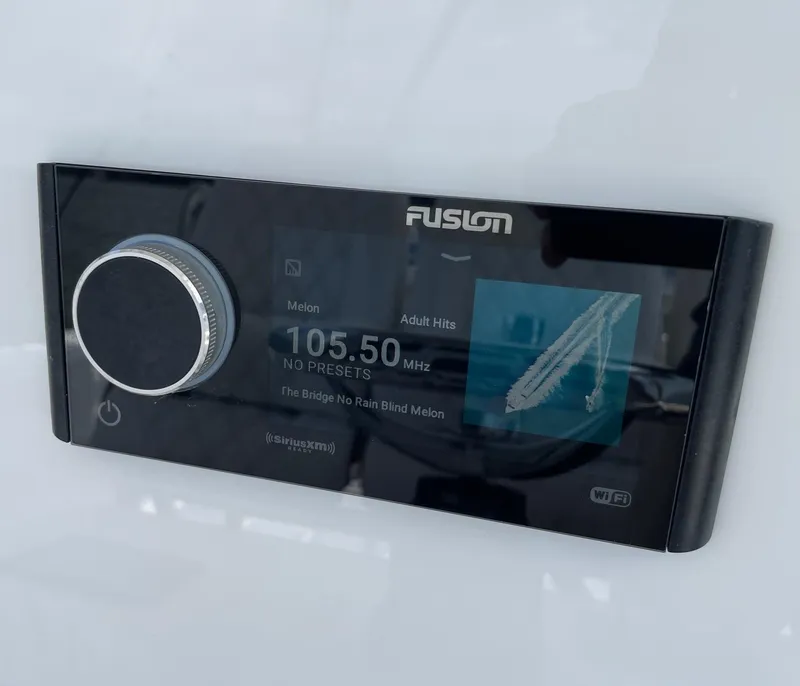 Slide: The Image of Fusion marine stereo display on 2009 Contender 39 Tournament boat, showing radio station 105.50 MHz. - 30