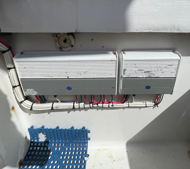 Slide: The Image of Electrical components in a 2009 Contender 39 Tournament boat, featuring wiring and protective casing. - 34