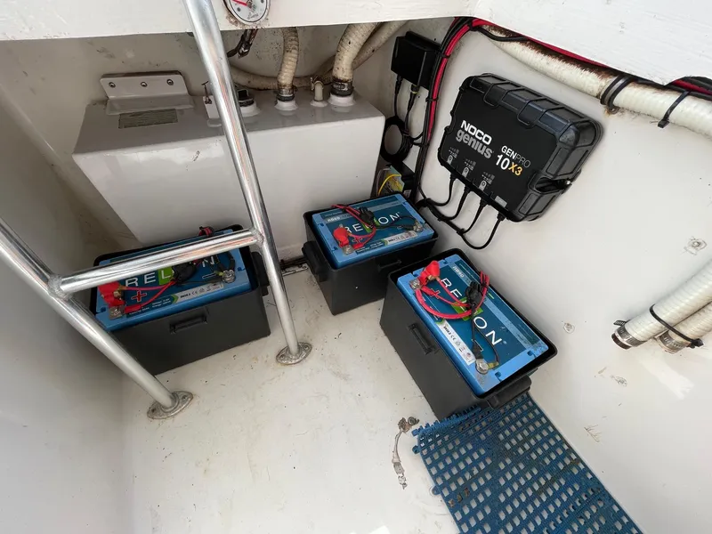 Slide: The Image of 2009 Contender 39 Tournament boat battery compartment with NOCO Genius charger and Relion batteries. - 38