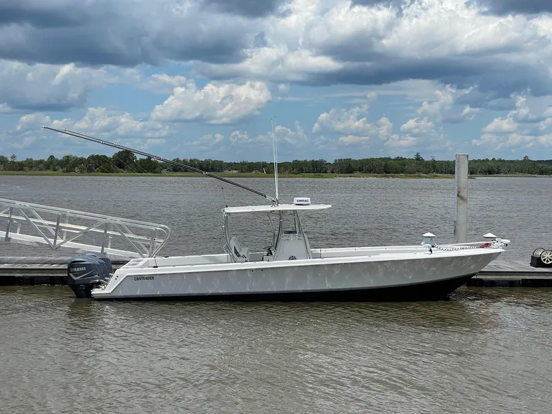Slide: The Image of 2009 Contender 39 Tournament boat docked by a river under cloudy skies. - 4