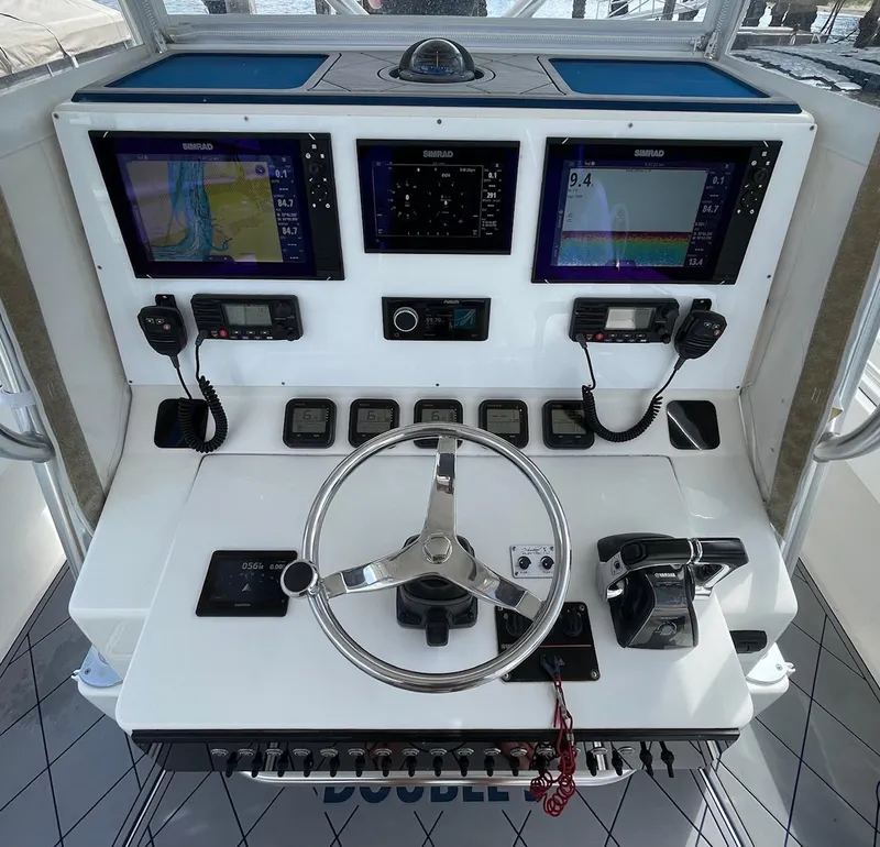 Slide: The Image of 2009 Contender 39 Tournament helm with Simrad displays and navigation controls. - 8