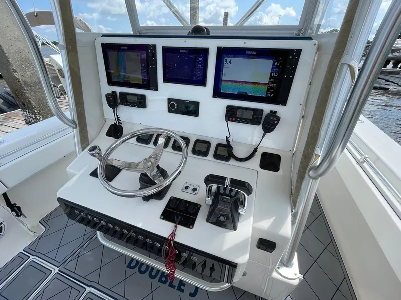 Slide: The Image of 2009 Contender 39 Tournament boat helm with navigation screens and controls. - 9