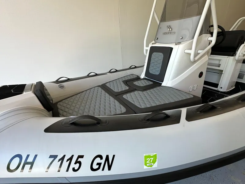 Slide: The Image of 2025 Highfield Sport 560 boat with gray seating and registration number OH 7115 GN. - 14