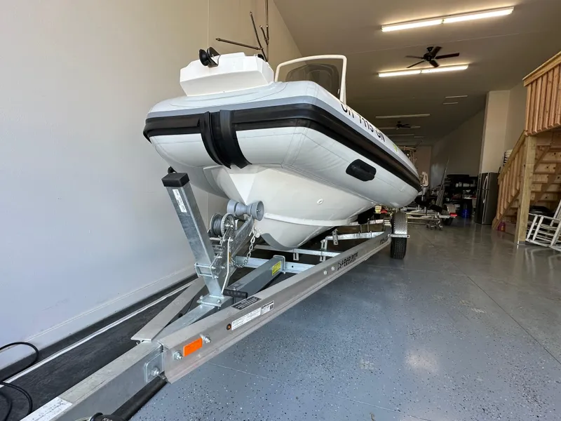 Slide: The Image of 2025 Highfield Sport 560 boat on trailer in a garage setting. - 15