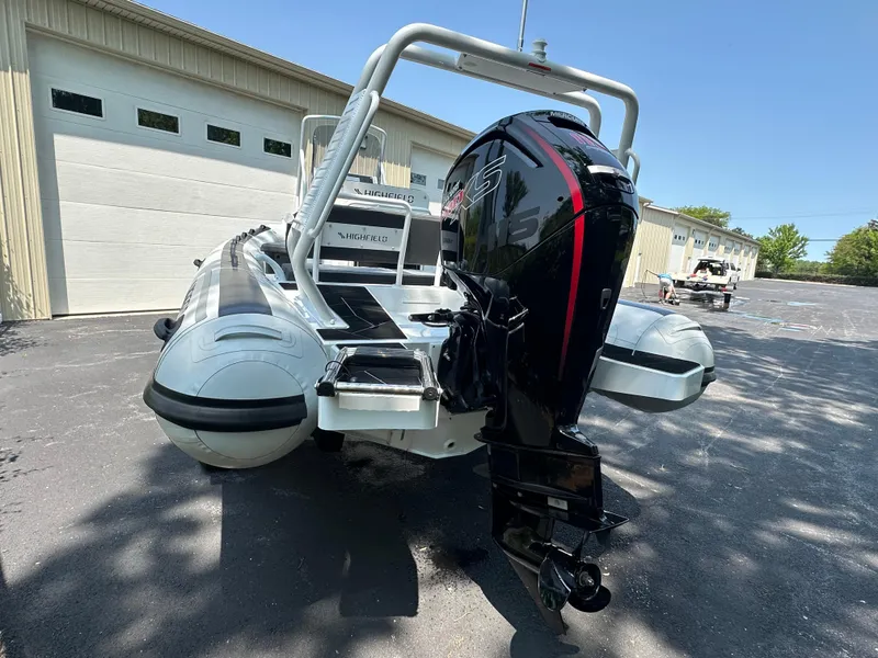 Slide: The Image of 2025 Highfield Sport 560 boat with powerful outboard motor, parked outdoors. - 4
