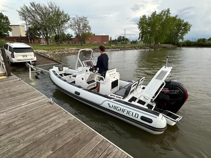 Slide: The Image of 2025 Highfield Sport 560 boat docked, featuring sleek design and powerful engine. - 6