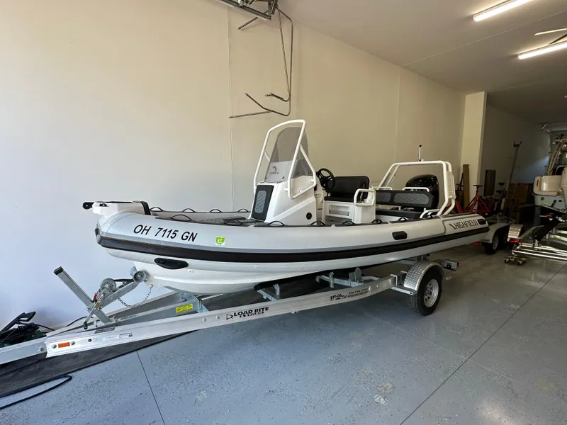 Slide: The Image of 2025 Highfield Sport 560 boat on trailer in a garage setting. - 8