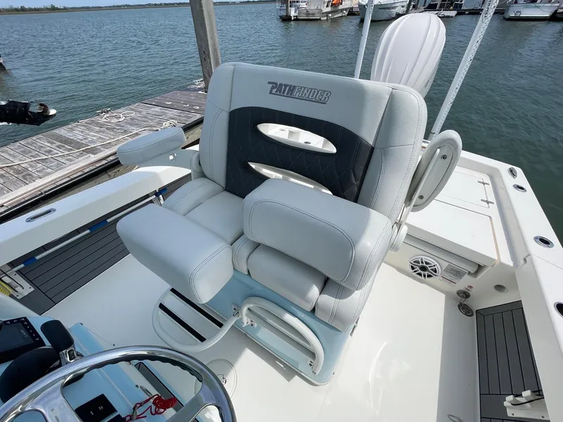 Slide: The Image of 2022 Pathfinder 2600 TRS boat seat, docked by the water. - 13