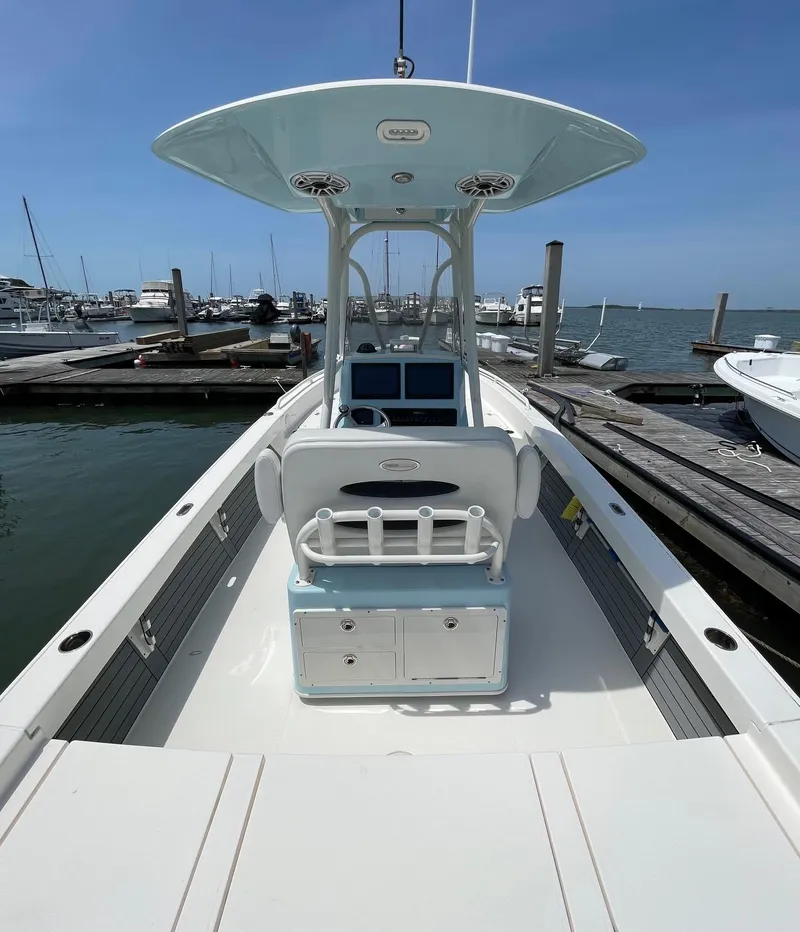 Slide: The Image of 2022 Pathfinder 2600 TRS boat docked at marina under clear blue sky. - 15