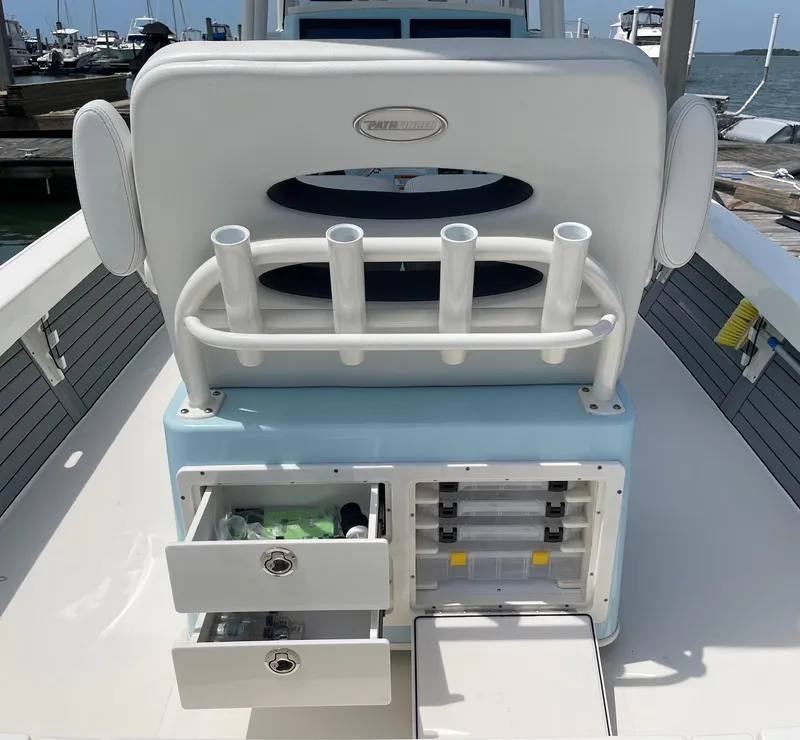 Slide: The Image of 2022 Pathfinder 2600 TRS boat with storage drawers and rod holders, docked at marina. - 17