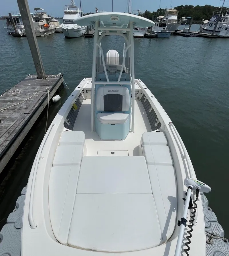 Slide: The Image of 2022 Pathfinder 2600 TRS boat docked at marina, featuring spacious deck and modern design. - 21
