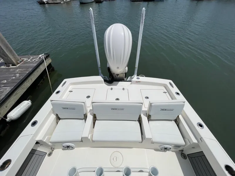 Slide: The Image of 2022 Pathfinder 2600 TRS boat with seating, docked on calm water. - 26