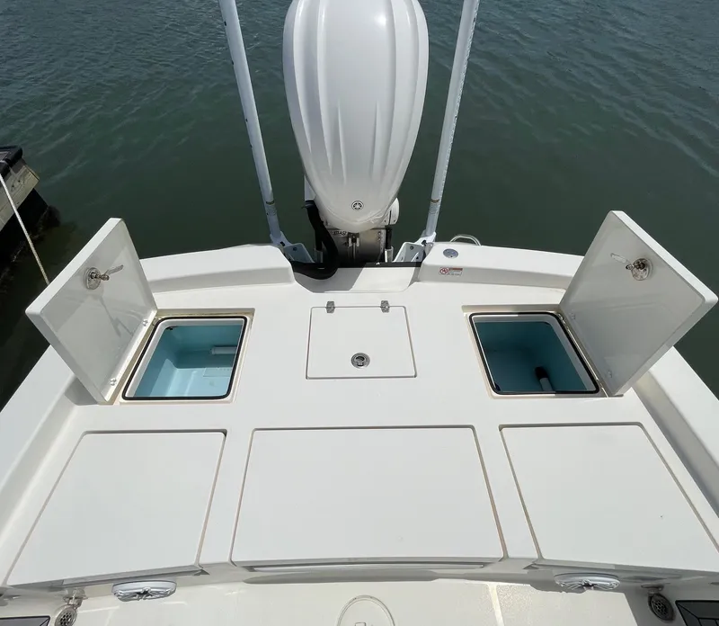 Slide: The Image of 2022 Pathfinder 2600 TRS boat with open storage compartments on deck. - 28