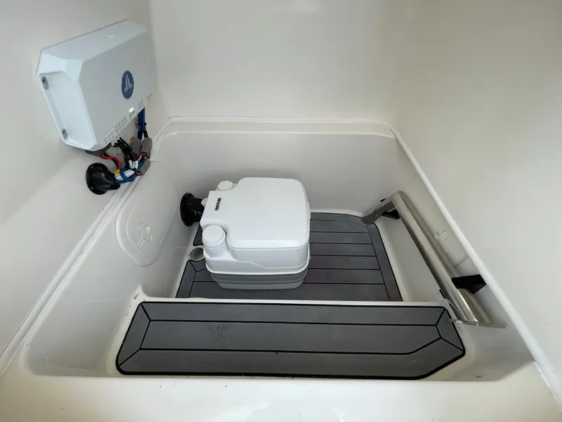 Slide: The Image of 2022 Pathfinder 2600 TRS boat interior with storage compartment and equipment. - 33