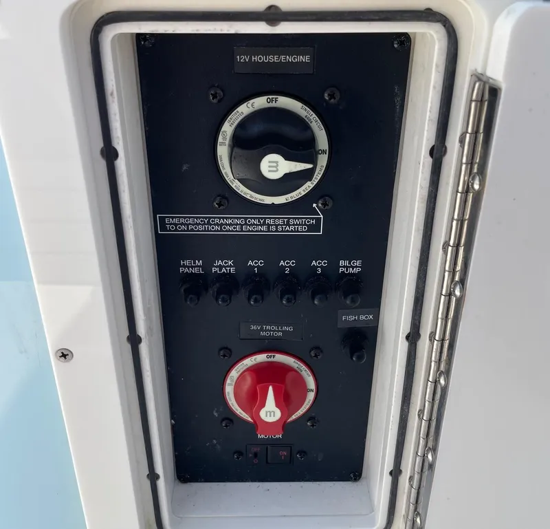 Slide: The Image of Control panel of a 2022 Pathfinder 2600 TRS boat, featuring switches and dials. - 34