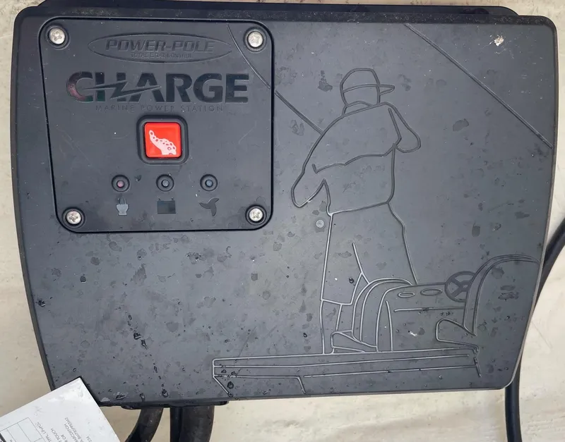Slide: The Image of Power-Pole Charge system on 2022 Pathfinder 2600 TRS boat, featuring engraved fishing scene. - 35
