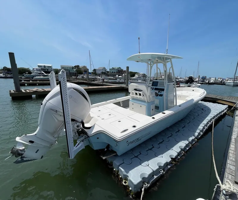 Slide: The Image of 2022 Pathfinder 2600 TRS boat docked at marina under clear blue sky. - 4