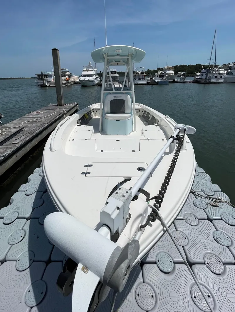 Slide: The Image of 2022 Pathfinder 2600 TRS boat docked at marina, clear sky, calm water. - 7