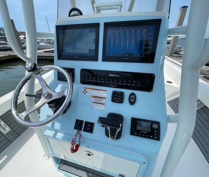 Slide: The Image of 2022 Pathfinder 2600 TRS boat console with steering wheel and navigation screens. - 9