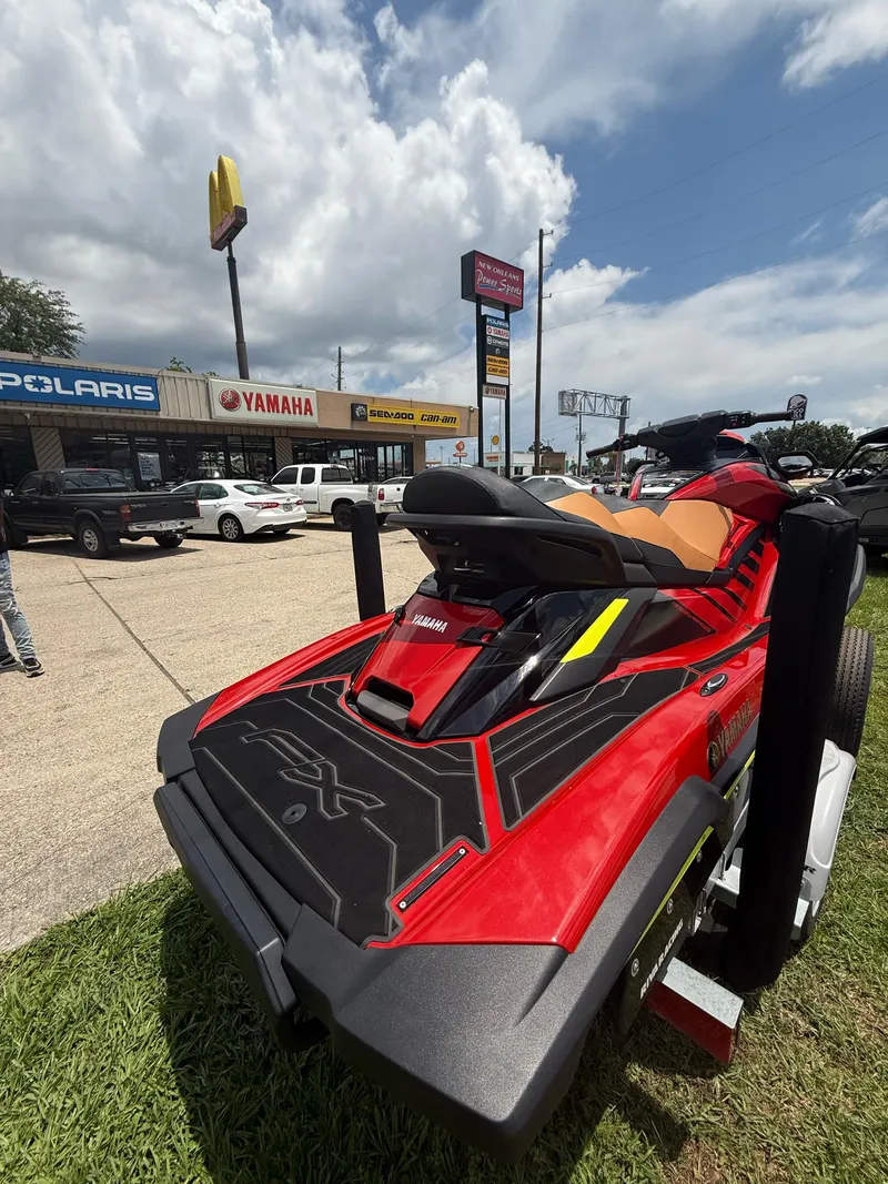 Slide: The Image of 2022 Yamaha FX Cruiser SVHO jet ski displayed outside dealership under cloudy sky. - 10