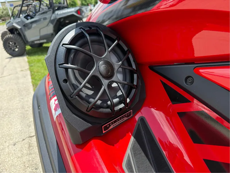 Slide: The Image of Red 2022 Yamaha FX Cruiser SVHO with mounted speaker, parked near an off-road vehicle. - 4