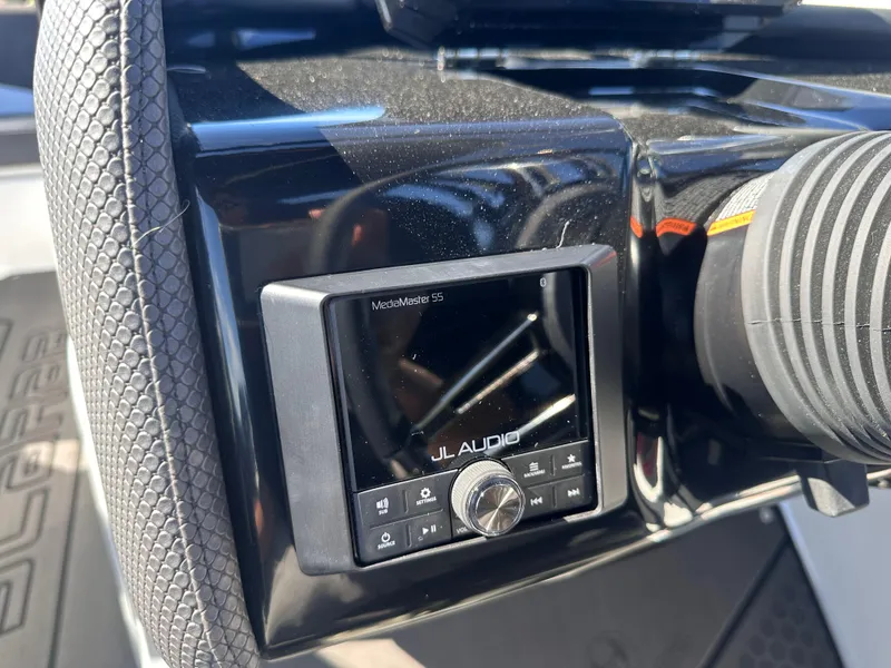 Slide: The Image of Control panel of 2025 Scarab 235 LX boat featuring JL Audio system. - 14