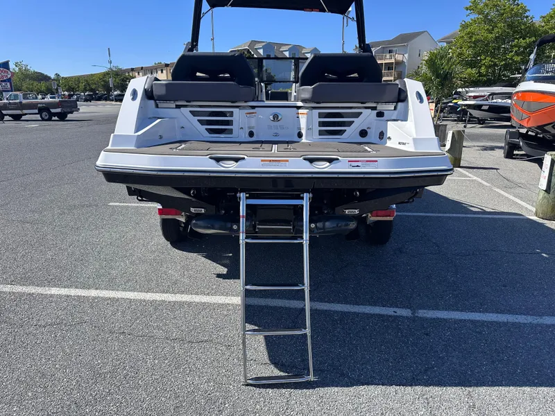 Slide: The Image of 2025 Scarab 235 LX boat with rear ladder in a parking lot. - 6