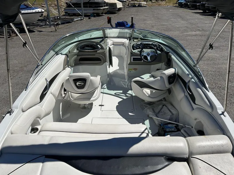 Slide: The Image of 2011 Crownline 220LS boat interior with white seating and steering wheel. - 18