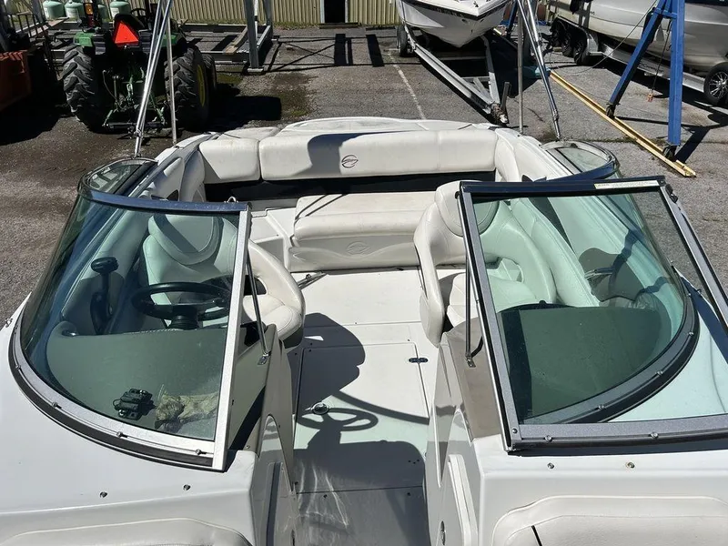 Slide: The Image of 2011 Crownline 220LS boat interior with white seating and windshield. - 21