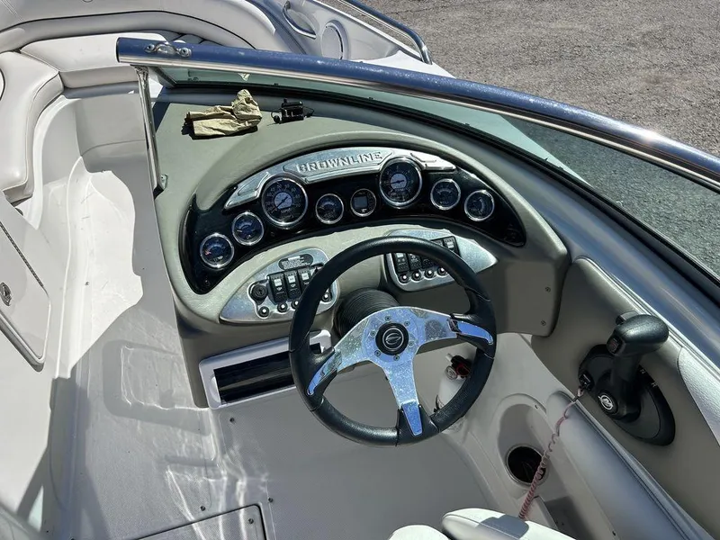 Slide: The Image of 2011 Crownline 220LS boat dashboard with steering wheel and instrument panel. - 22