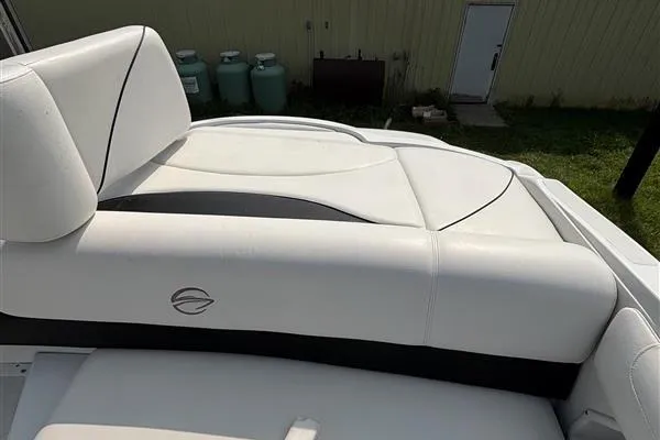 Slide: The Image of 2011 Crownline 220LS boat with white leather seating and logo detail. - 23