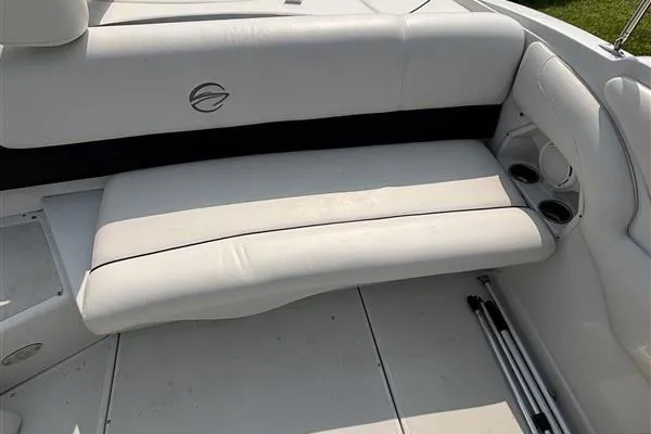 Slide: The Image of White interior seating of a 2011 Crownline 220LS boat with cup holders. - 25