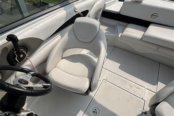 Slide: The Image of 2011 Crownline 220LS boat interior with white seating and steering wheel. - 28