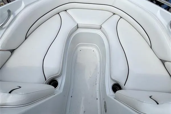 Slide: The Image of 2011 Crownline 220LS boat interior with white cushioned seating and cup holders. - 29