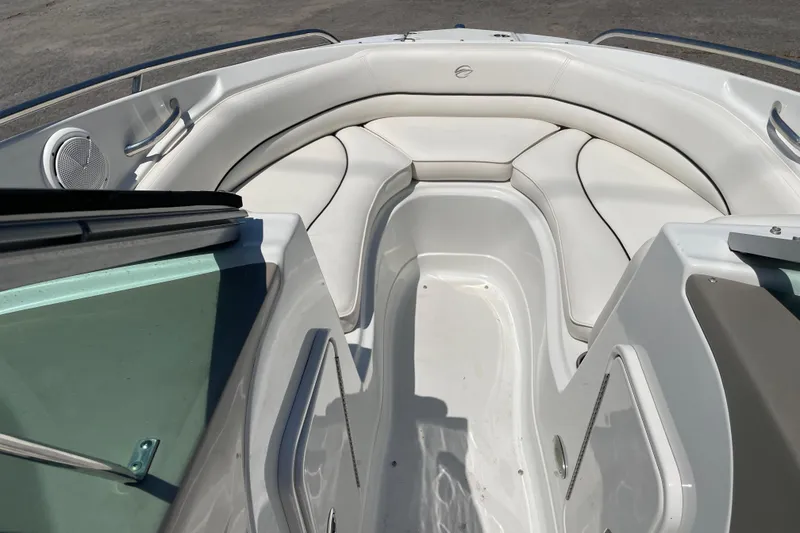 Slide: The Image of 2011 Crownline 220LS boat interior with white seating and speaker. - 31
