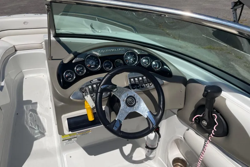Slide: The Image of 2011 Crownline 220LS boat dashboard with steering wheel and control panel. - 33