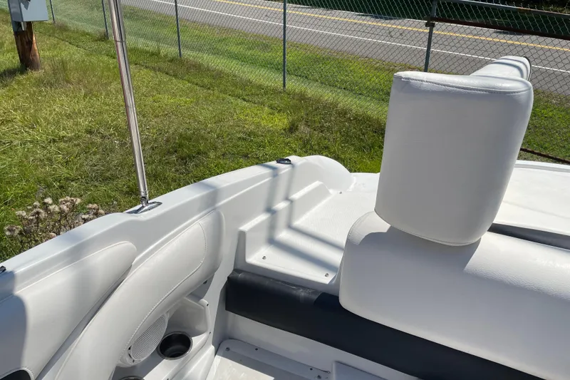 Slide: The Image of 2011 Crownline 220LS boat interior with white seating and cup holder. - 35