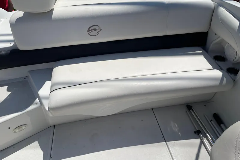 Slide: The Image of 2011 Crownline 220LS boat interior with white seating and cup holders. - 37