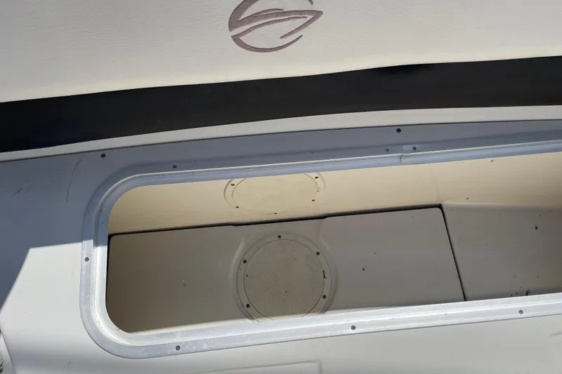 Slide: The Image of Storage compartment of a 2011 Crownline 220LS boat, featuring a clean interior. - 38