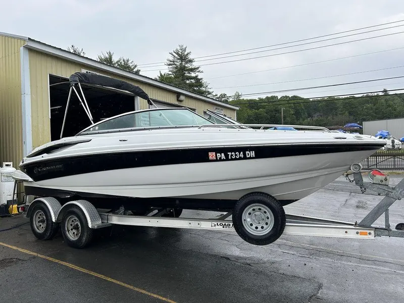 Slide: The Image of 2011 Crownline 220LS boat on trailer outside a warehouse. - 9