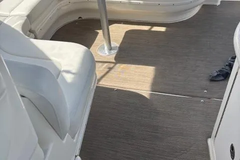 Slide: The Image of Interior view of 2003 Sea Ray 340 Sundancer boat with white seating and wooden flooring. - 17