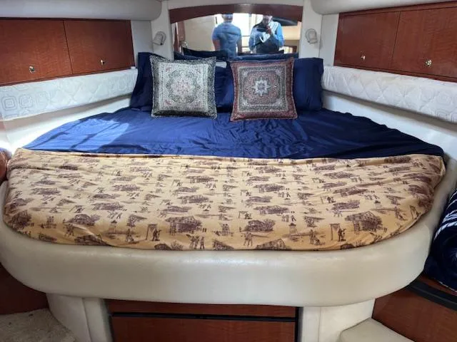 Slide: The Image of Interior cabin of 2003 Sea Ray 340 Sundancer with cozy bed and decorative pillows. - 2