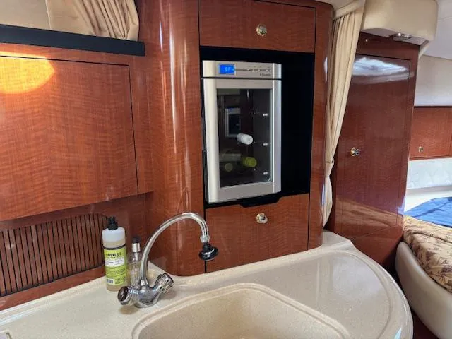 Slide: The Image of Luxurious 2003 Sea Ray 340 Sundancer yacht interior with kitchenette and mini fridge. - 5